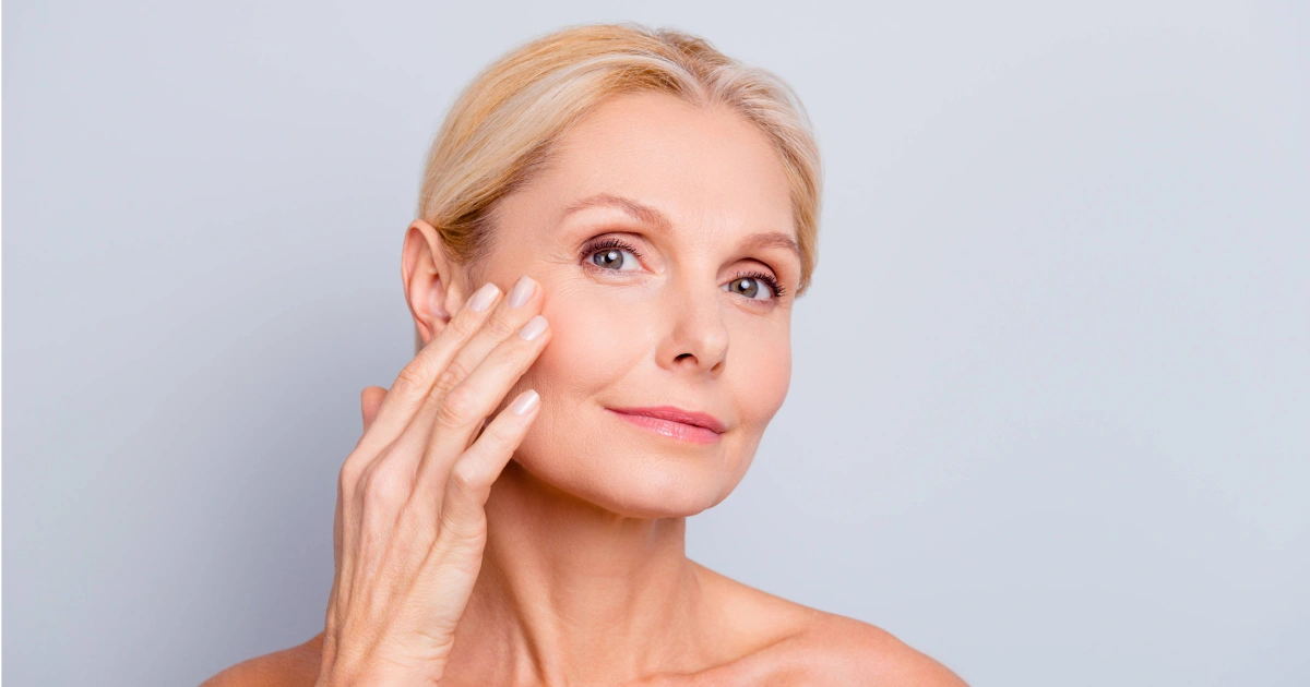 Smiling middle-aged woman with glowing skin after facial treatment in Great Neck, NY | Evolve Spa
