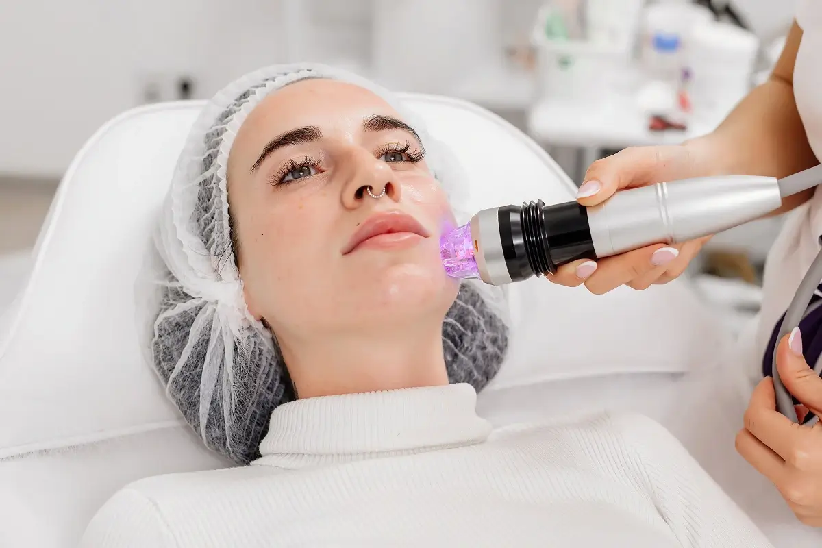 Client undergoing Secret RF Microneedling treatment with a handheld device in Great Neck, NY | Evolve Spa